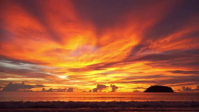 .smooth waves in colorful sky in sunset at Kata beach Phuket..Scene of romantic sky sunset with tellow cloud moving. .beautiful golden sky at sunset above island in nature and travel concept..