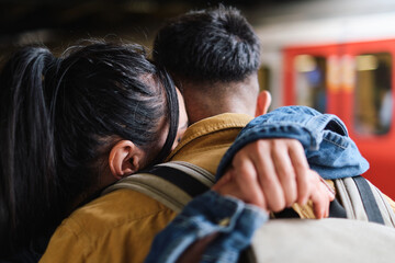 Fototapeta premium Young couple saying goodbye in the subway