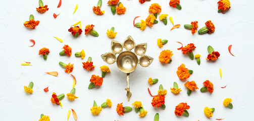 Oil lamp with marigold flowers on white background. Divaly celebration