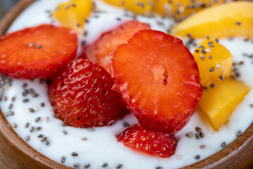 fresh yogurt made from milk with pieces of strawberries
