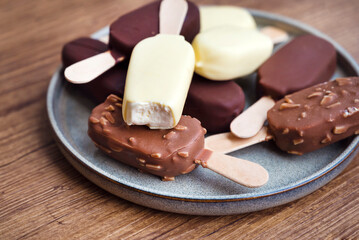 Ice cream sticks with chocolate and almonds
