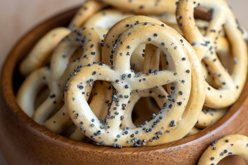 Poppy seed coating dried bagels on the table