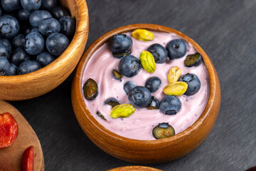 fresh blueberry-flavored yogurt with ripe blueberries and pistachios