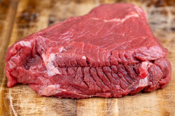 sliced piece of fresh raw beef during salting