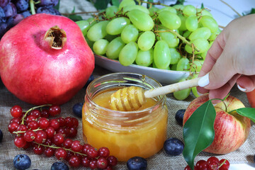 Jewish New Year - Rosh Hashanah, photo for the Jewish holiday. Honey, Apple and Pomegranate - main fruits on Jewish holiday tables on days celebrate Rosh Hashanah in Israel
