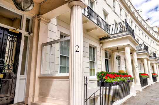 London, England - July 11, 2023: A row of townhomes with elegant porticos and gardens along Wilton Crescent in the Belgravia district of London
