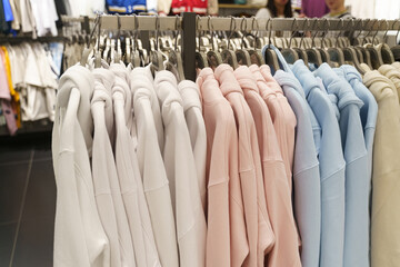 Women's sweatshirts hang on hangers in a clothing store.