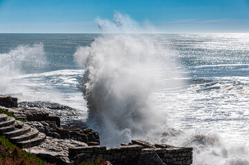 sea waves crashing on shoreline rocks