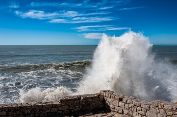 Fototapeta na wymiar sea waves crashing on shoreline rocks
