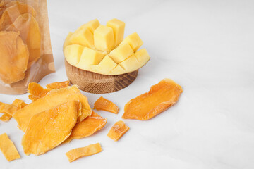 Slices of dried mango on white background