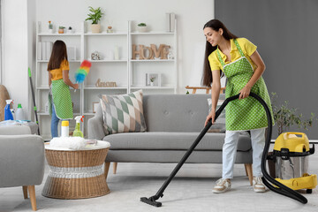 Happy mother with her little daughter cleaning at home