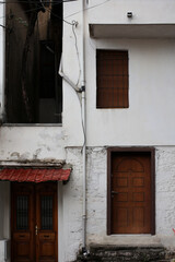 Old door and windows damaged from weather in ancient city of Gjirokaster in Albania exploring...