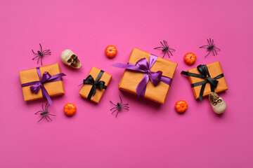 Composition with different gifts and Halloween decorations on pink background