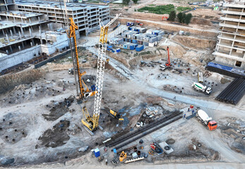 Deep foundation machine. Drilling rig and Pile driver at construction site. Pile driven into ground...