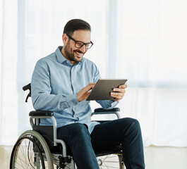 disability wheelchair disabled man handicap sitting handicapped health young wheel care invalid tablet online communication usine device technology healthcare