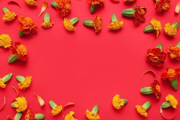Frame made of marigold flowers on red background. Divaly celebration