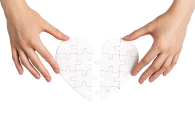 Hands matching two parts of puzzle heart, isolated on white