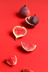 Fresh juicy cut figs on red background