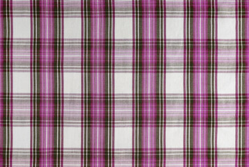 Pink checkered texture fabric, tartan pattern. Shirt fabric, tablecloth textile, linen plaid cloth, classic scottish check pattern. Backdrop, wallpaper, background.