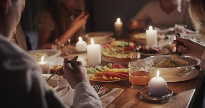 Happy family has a festive dinner in honor of Thanksgiving, they sit at the festive table with delicious food