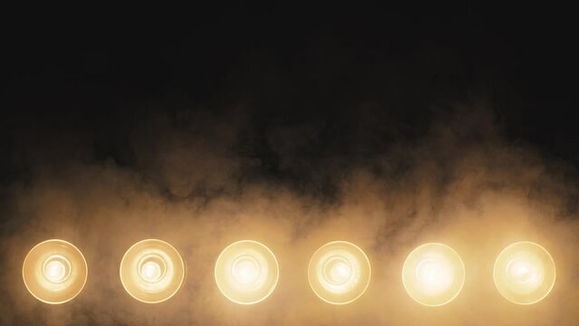 Yellow glow of spotlights in smoke