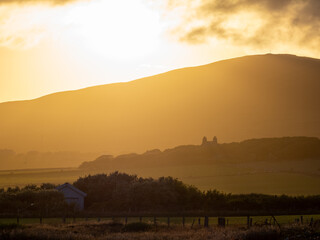 The sun sets behind the hills of Orphir, Mainland, Orkney, Scotland