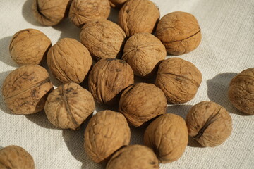 Plenty walnuts on a white tablecloth