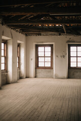 Very old abandoned factory warehouse with wooden floors and windows and clay tiles.