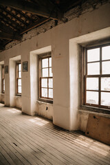 Very old abandoned factory warehouse with wooden floors and windows and clay tiles.