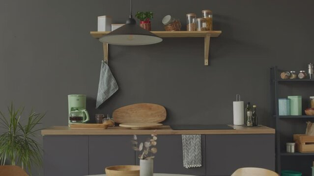 No people shot of minimalist kitchen interior with white table, grey furniture and wooden elements of design