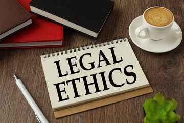 legal ethics working environment with notepad and cup of coffee.words