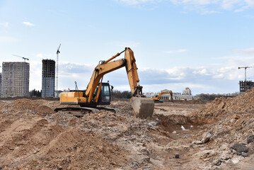 Excavator dig ground at construction site. Dig foundation. Construction of residential buildings...