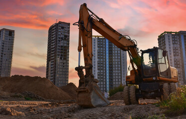 Excavator dig ground at construction site. Dig foundation. Construction of residential buildings...