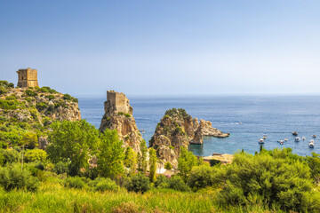 Fototapeta na wymiar Faraglioni of Scopello - The stacks of Scopello, rocky peaks at sea near of Castellammare del Golfo town at northwestern Sicily, Italy, Europe.