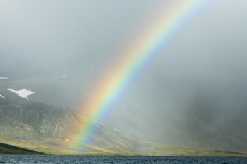 large rainbow in the mountains