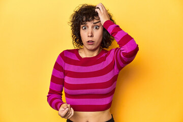 Caucasian curly-haired woman in pink striped-top being shocked, she has remembered important...