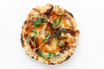 Thai pizza VEGAN with vegan cheese, sun-dried tomato, pineapple, sweet chilli sauce on white background. Pizza top view.
