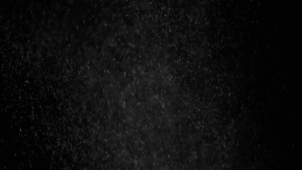 Strong Snowstorm with Wind and Falling Snow Particles on a Black Background. Explosion, collision. White flakes of snow, particles of powder swirl, fly, and mix in empty space. Blizzard, storm. Dust.