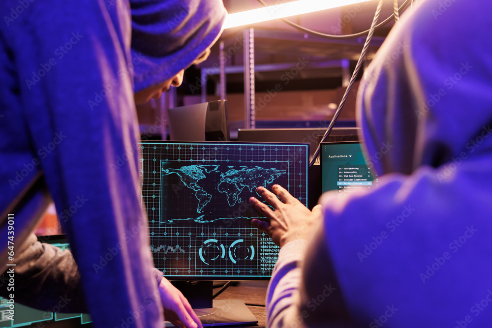Poster hackers spying online and checking confidential data on computer screen. two criminals in hoods coll