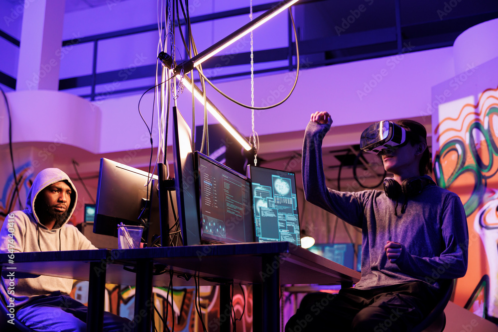 Poster hacker in vr glasses cracking password while breaking into online server in metaverse. criminal wear