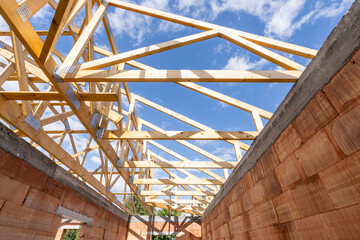 Low angle view of support roof beams and ceilings in new building