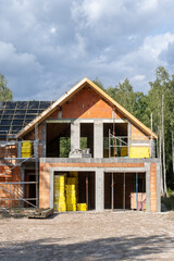 Brick house with wooden rooftop and modern attic space with large mansard windows