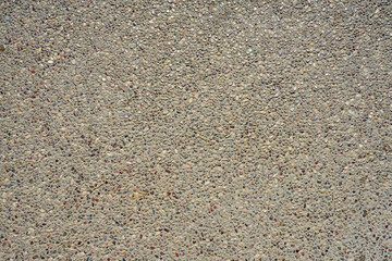 The road surface is lined with small pebbles as a background.