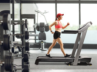 Female exercising on a treadmill at the gym
