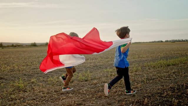 Polish little cute boys running Poland national flag. Patriotism. 11 November