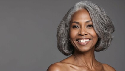 Gorgeous mature woman with long gray hair and smooth healthy skin smiling happily in beauty and cosmetics skincare advertising concept