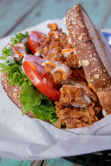 Delicious crispy chicken sandwich fried style, with vegetables, delicious and healthy, with homemade dressing.