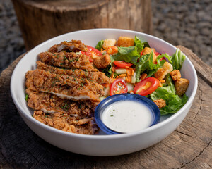 Delicious salad with crispy chicken and dressing, healthy food.