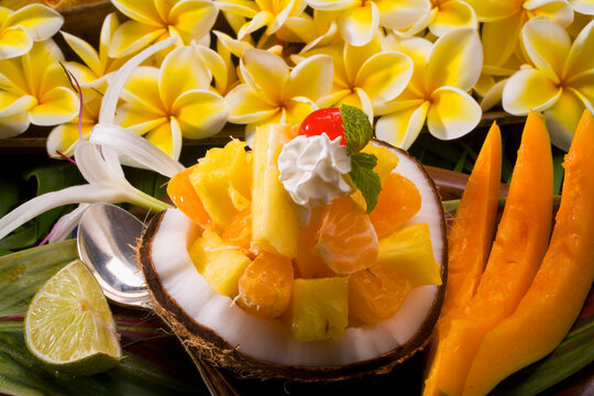 Studio Shot Of A Tropical Fruit Salad With Flowers.