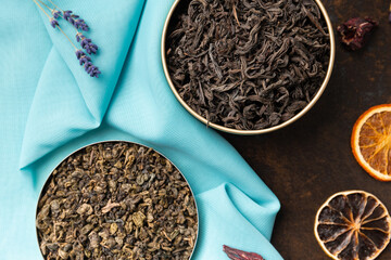 Assorted tea and citrus chips on a dark background top view.